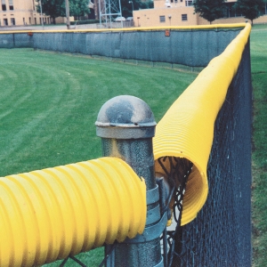 yellow fence topper on high school baseball fence